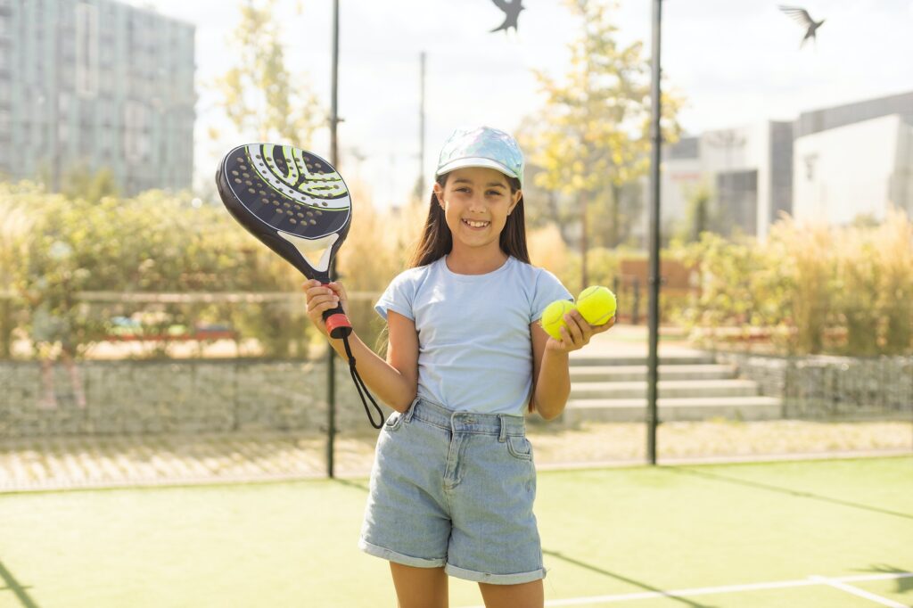 little girl playing padel outdoor